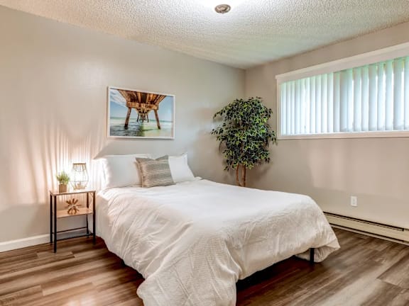 a bedroom with a bed and a window