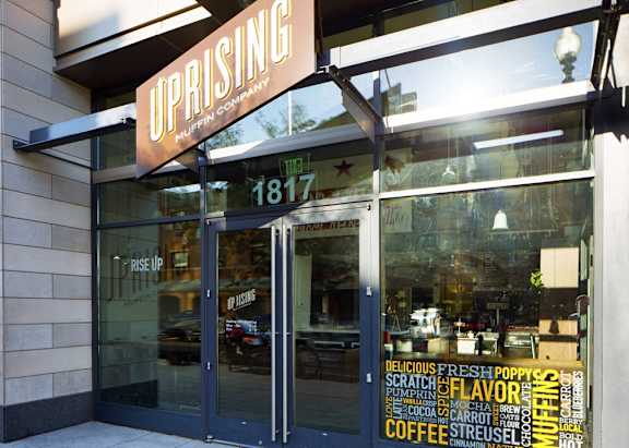 a view of the front of a coffee shop with a sign on the front door