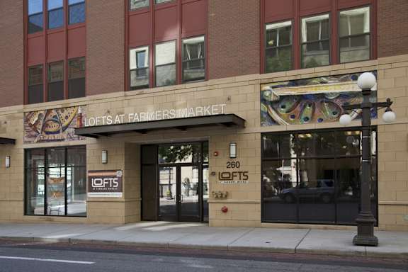 the facade of a hotel at farmers market on a city street