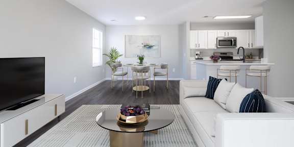 A modern living room with a white sofa and a glass coffee table.