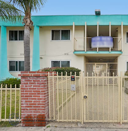 A building with a gate and a sign that says "Property Management".