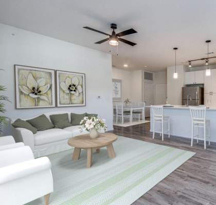 an open living room and kitchen with a ceiling fan