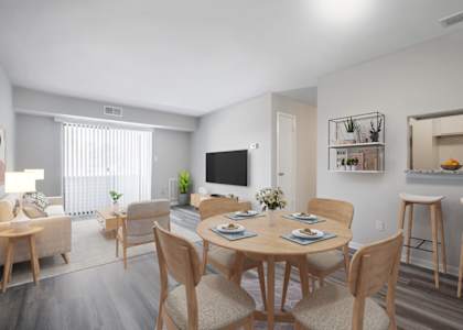 A dining room with a wooden table and chairs.