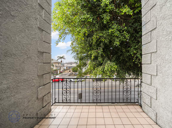 A view from a gate looking out onto a street.