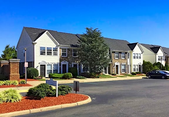 a row of houses on a street with a parking lot
