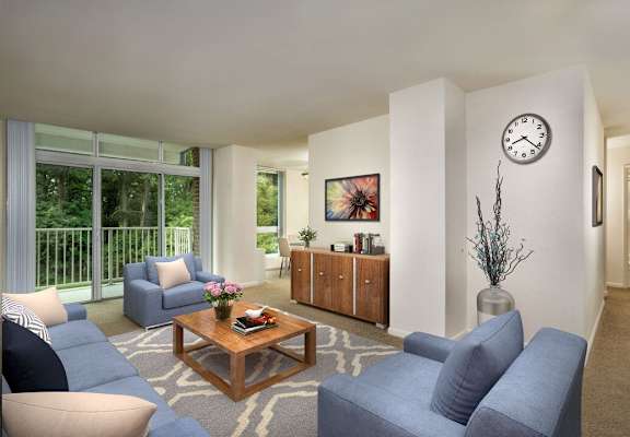 A living room with a sofa, armchair, and coffee table. at Charlestowne North Apartments, Maryland