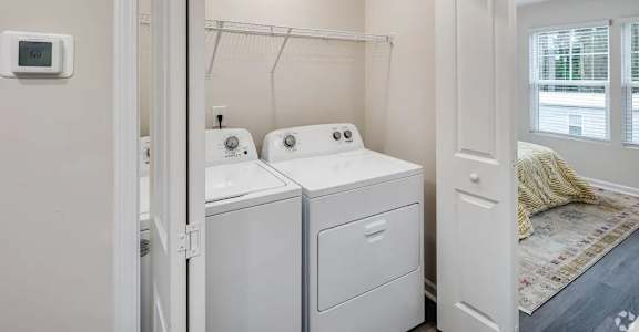 A small laundry room with a washer and dryer.