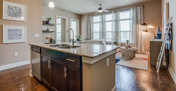 A kitchen with a sink and a counter.