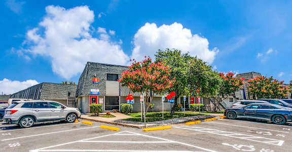 a parking lot with cars in front of a building