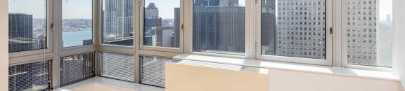 A room with a large window overlooking a cityscape.at 'The Metropolis', New York, NY