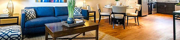 a living room with a couch and a table at Parkside at Five Points Apartments, Raleigh , 27608