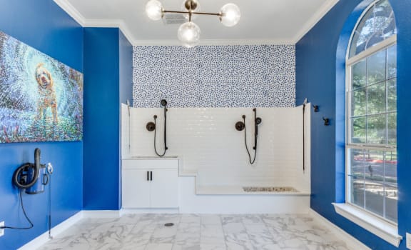 a bathroom with blue walls and white marble floors