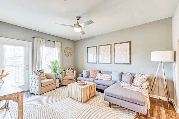 a living room with furniture and a ceiling fan at the flats at sundown luxury apartments in north port florida
