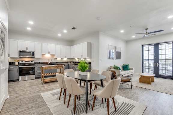 A modern kitchen with a dining table set up.