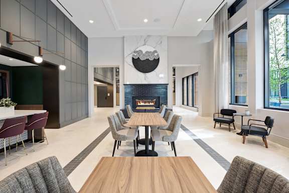 A modern dining room with a wooden table and chairs.