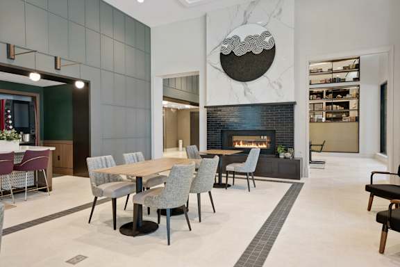 A modern dining room with a fireplace and a TV.