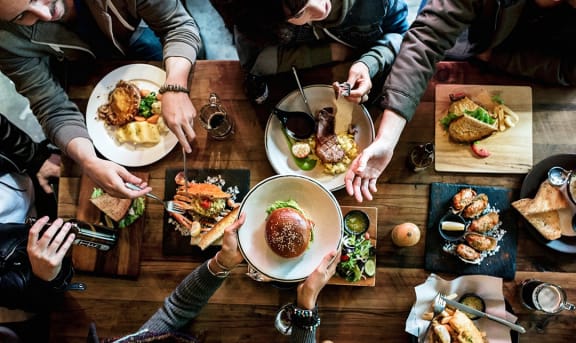 a group of people sitting around a table drinking wine