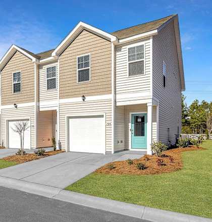 A row of houses with a clear blue sky above them.