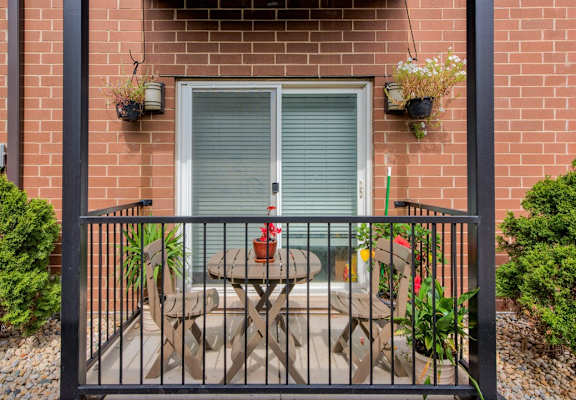 a patio with a table and chairs on a balcony