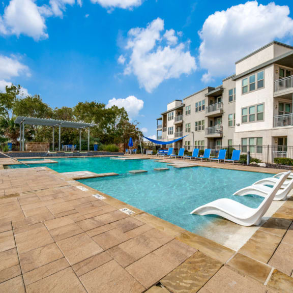 our apartments have a large pool and a playground for kids at The Landings at Brooks City-Base, San Antonio, TX