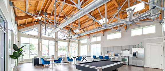 a game room with a pool table in the middle at The Landings at Brooks City-Base, San Antonio
