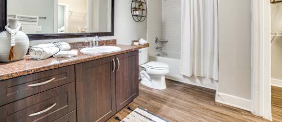a bathroom with a large mirror and a shower and a toilet at The Landings at Brooks City-Base, Texas, 78235