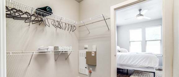 a bedroom with a closet and a bed and a mirror at The Landings at Brooks City-Base, Texas, 78235