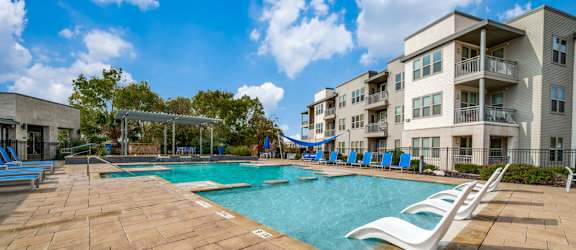our apartments have a large pool and a playground for kids at The Landings at Brooks City-Base, Texas, 78235