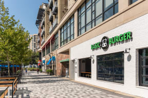 a building with a burger restaurant on the side of a street