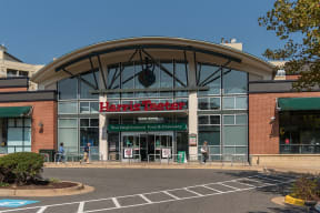 the front of a shopping center with a large building with a sign on the front