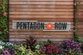 a sign row on a wooden wall with flowers