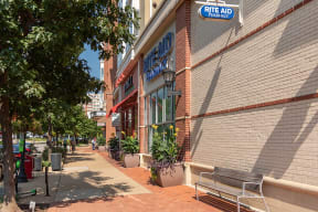 a bench in front of a building on a sidewalk