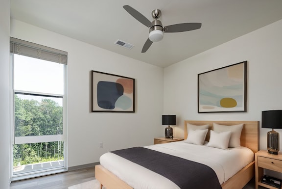 a bedroom with a bed and a ceiling fan