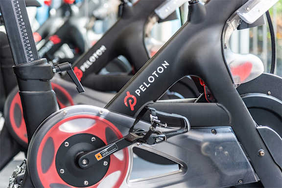 a group of bicycles parked in a row with a red and black steering wheel