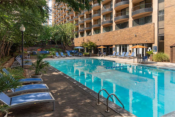 a swimming pool in front of a hotel