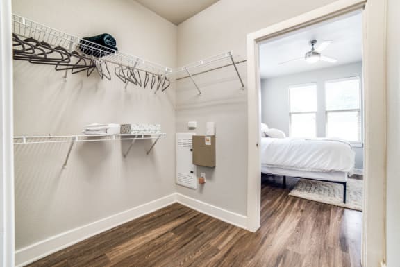 a bedroom with a closet and a bed and a mirror at The Landings at Brooks City-Base, San Antonio, TX, 78235