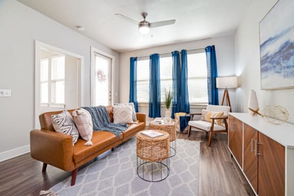 a living room with a couch and a dining room table at The Landings at Brooks City-Base, San Antonio, TX, 78235