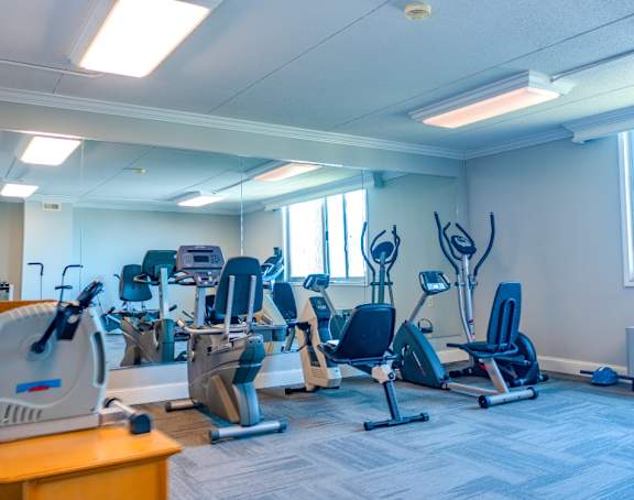 a room filled with lots of different types of cardio equipment