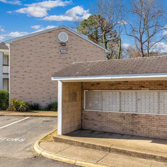 A brick building with a white awning and a calendar on the wall.