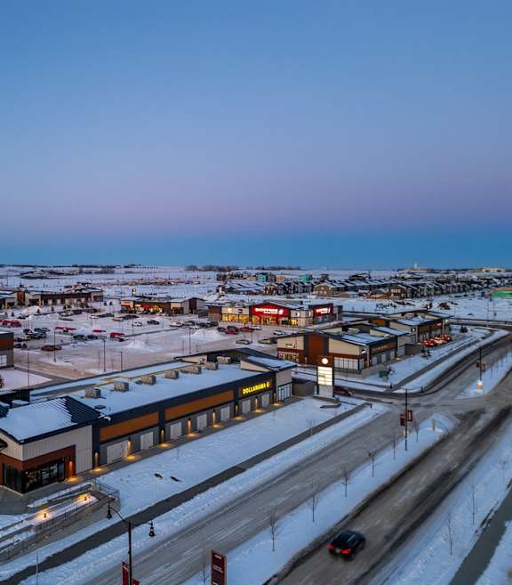 A Safeway store is seen from a distance with a parking lot in front.