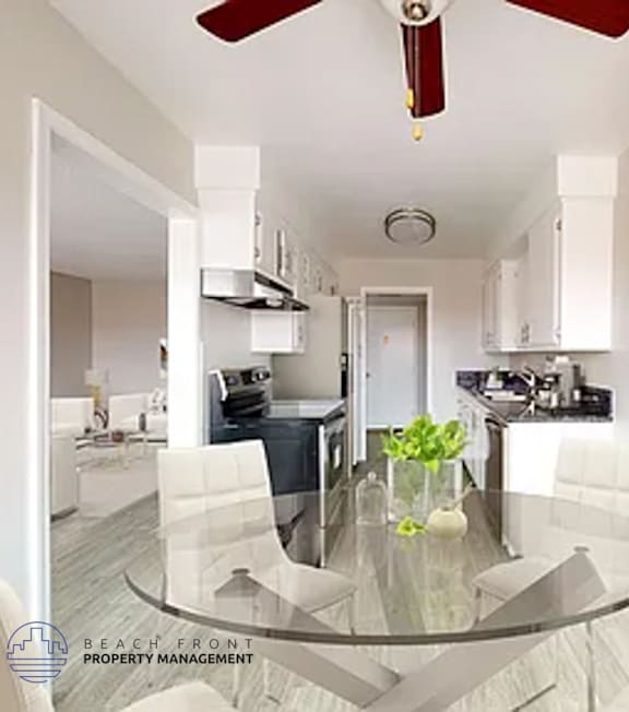 A modern kitchen with a glass table and white chairs.