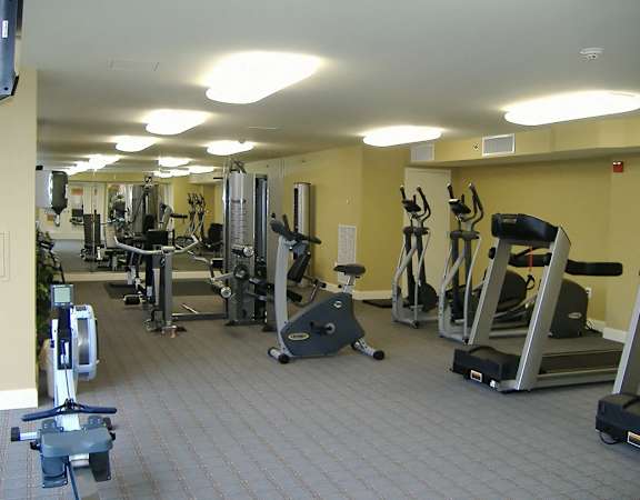 A gym with a variety of exercise equipment.