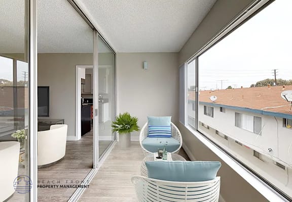 A modern balcony with a chair and a table.