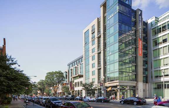 a view of a city street with cars and buildings