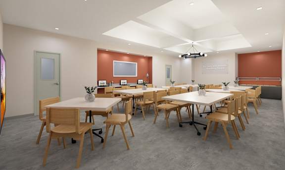 A conference room with a long table and chairs.