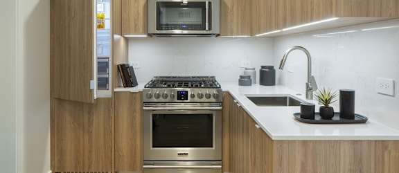 a kitchen with a stove and a sink and a microwave