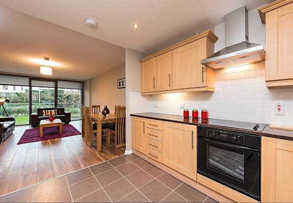 a kitchen and living room with a table and chairs
