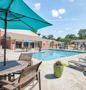 our apartments offer a swimming pool with tables and chairs at Brightwaters Apartments, Little Rock, Arkansas