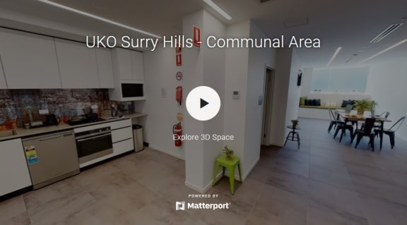 a room with a kitchen and a table
