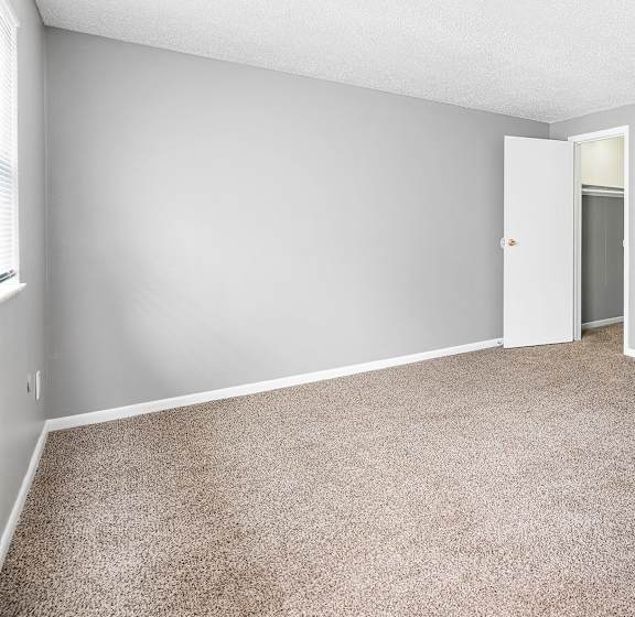 A room with two white doors and a ceiling light.